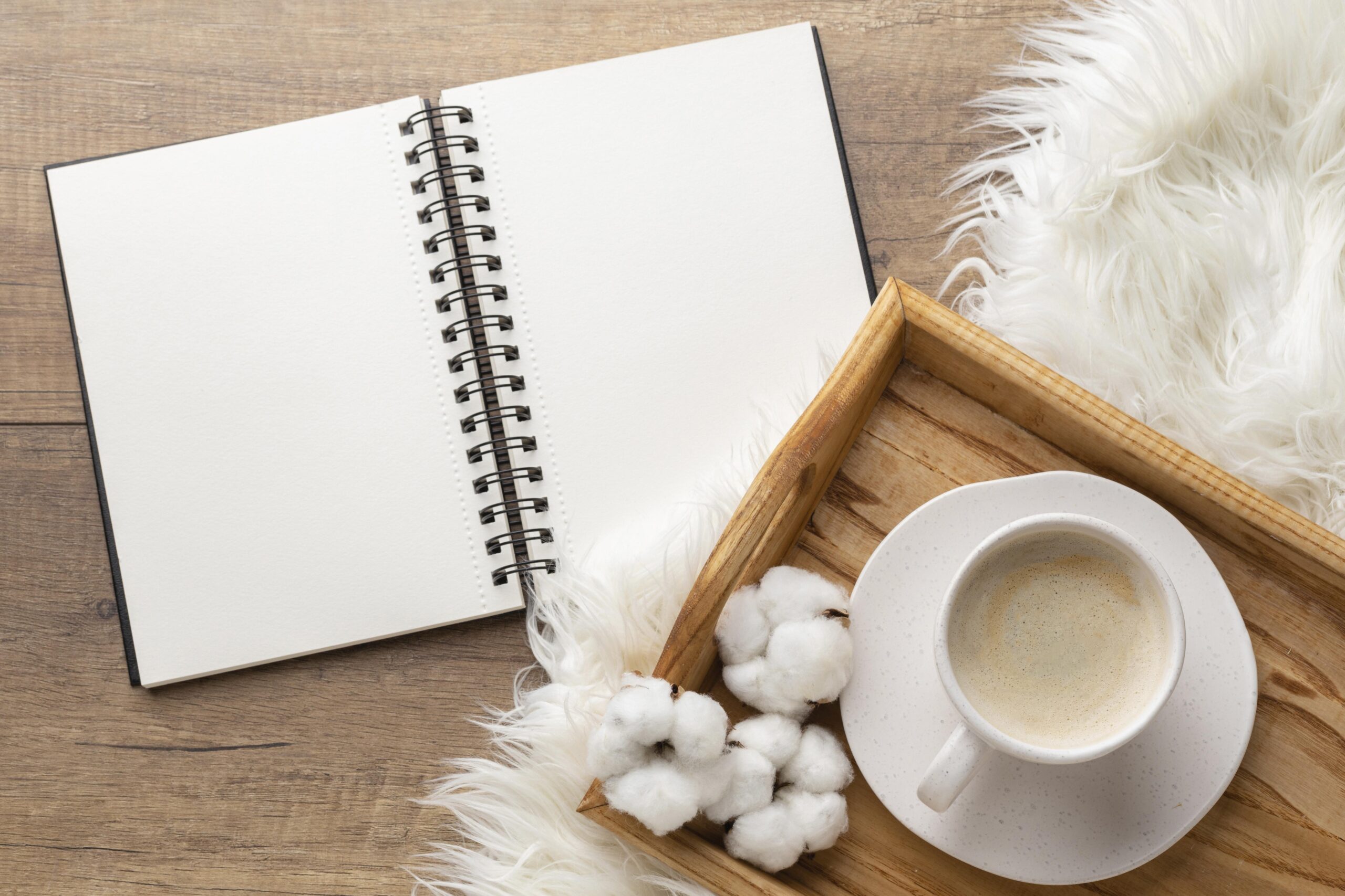 top view notebook with cup coffee cotton flowers